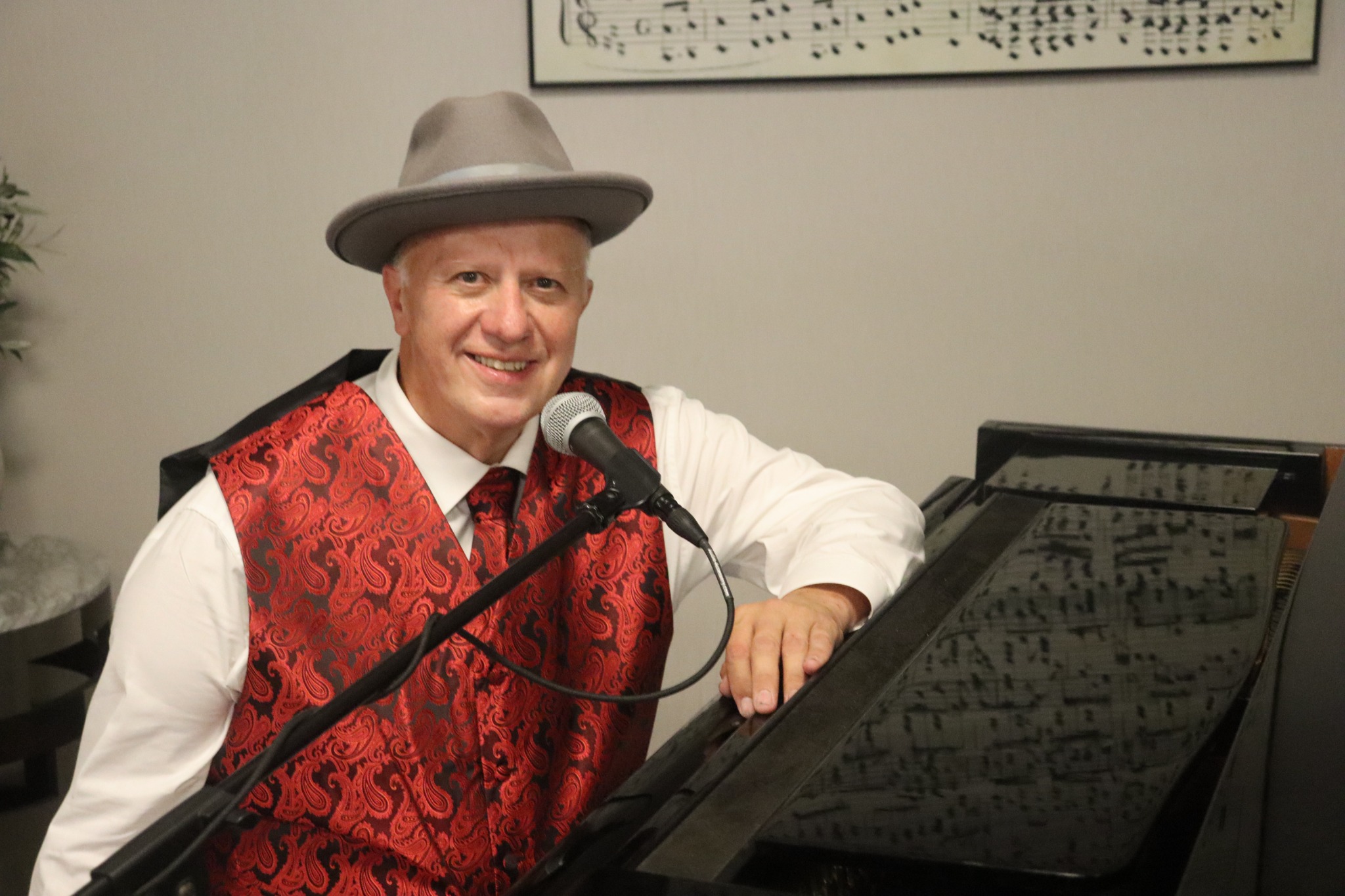 David Scott Brown at the microphone beside the piano
